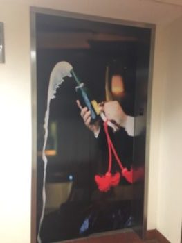 Open champagne bottle elevator graphic 