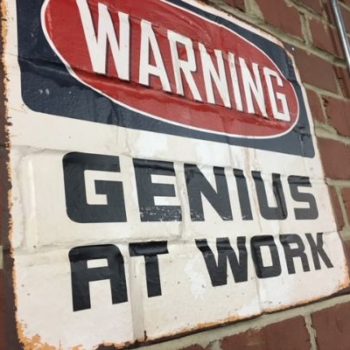 Warning sign over brick 