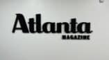 black acrylic logo on a white wall