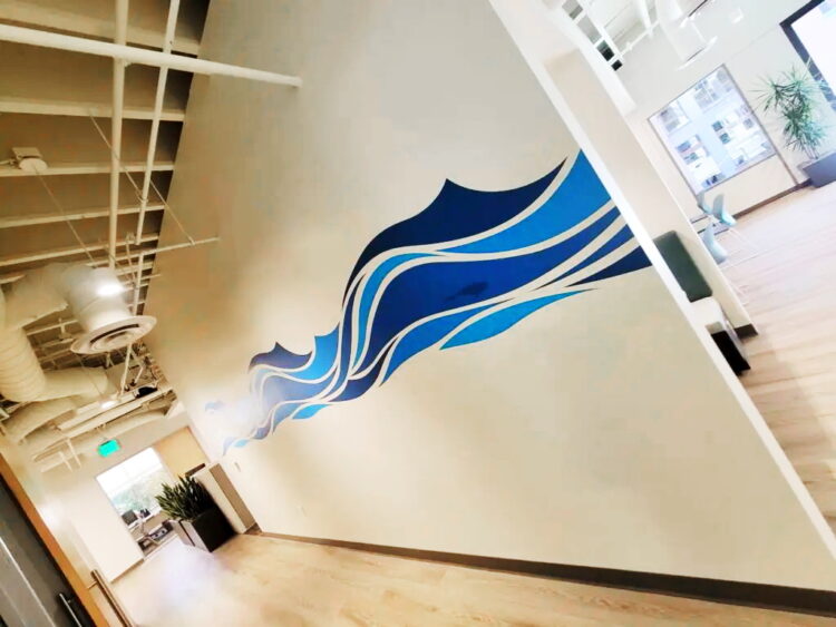 Cut vinyl of stylized waves across middle of wall