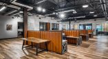 Stronghold Executive offices, eight back to back cubicles in the foreground with vinyl mural on the back wall