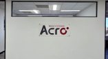 Rectangular acrylic wall sign mounted with standoffs on white wall in office space San Diego, CA.