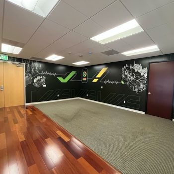 Interior corner wall mural with technical illustrations and graphics on black wall in San Diego, CA.