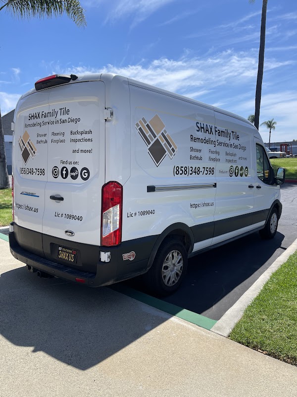 White commercial van with full vehicle wrap signage showing tile company branding in San Diego, CA.