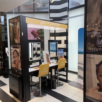 Freestanding retail display with printed panels and branded chair covers in San Diego, CA.
