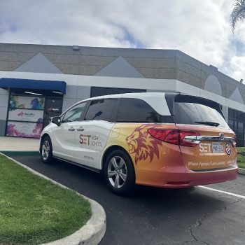Commercial fleet vehicle wrap on a white minivan with lion graphic in San Diego, CA.