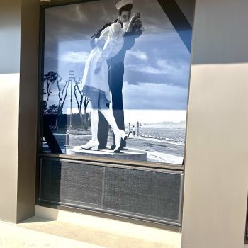 Black and white window graphic of a sailor kissing a nurse on a building window in San Diego, CA.