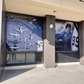 Two large window graphics with black and white aviation images on building windows in San Diego, CA.