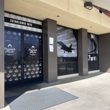 Window graphics with airplane and bridge images and logo decals on glass doors in San Diego, CA.