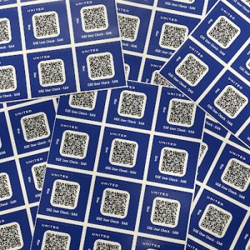 Sheets of blue vinyl QR code stickers with white squares printed in San Diego, CA.