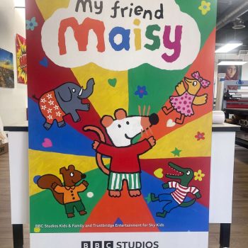 Large colorful printed lobby sign with cartoon characters in San Diego, CA.