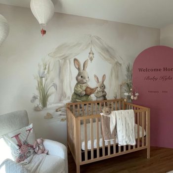 Painted wall mural of rabbits reading books in a nursery room in San Diego, CA.