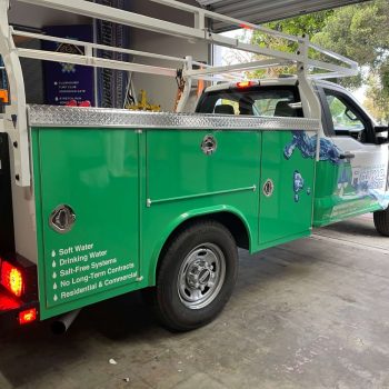 Partial commercial fleet wrap with green and blue water graphics on a white truck in San Diego, CA.