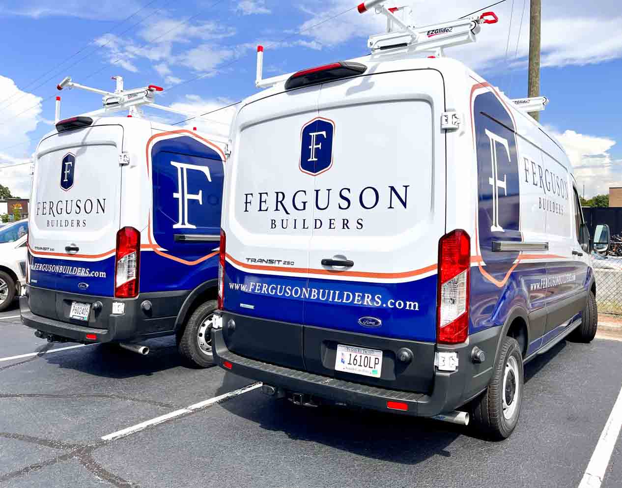 Ferguson fleet in partial wraps showcasing blue and gold colors and contact info.
