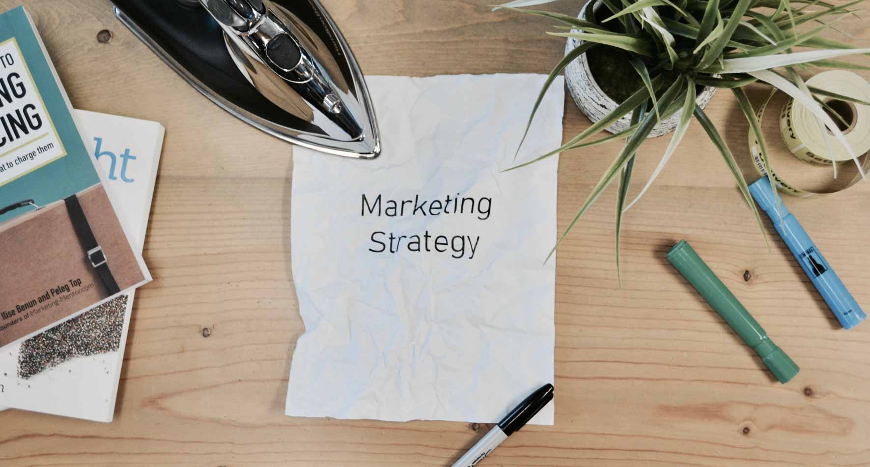 Image of a crumpled piece of paper with "Marketing Strategy" printed on it