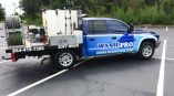 Wash Pro flatbed cab wrap with two tones of blue, logos, contact info and services.