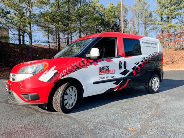 Full red and black tire themed wrap on a van for a local tire company.