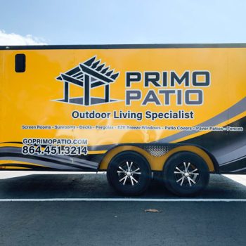 Partial monochrome wrap on a yellow trailer for a patio company.