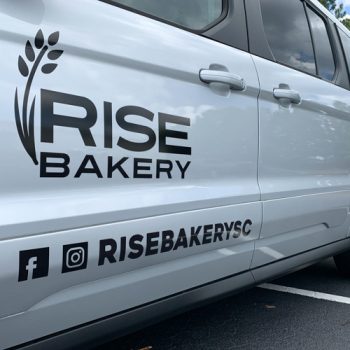 Die-cut lettering on the side of Rise Bakery's van.
