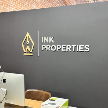 Dimensional logo for office in brushed aluminum and brushed gold.