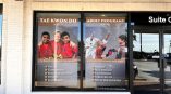 Storefront window perf showcasing a martial arts studio's programs.