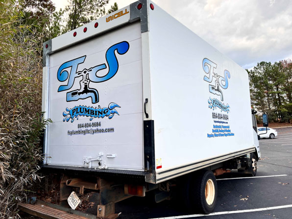 Large plumber's logos on a box truck.
