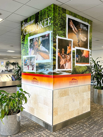 Column advertisements with a river background and Cherokee attraction images on top.
