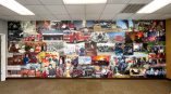 Custom fire department history wall mural collage in training room.
