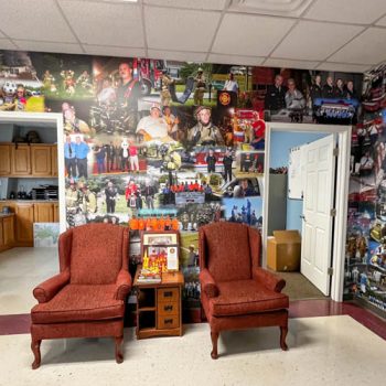 Custom fire department history wall mural collage in lobby area.