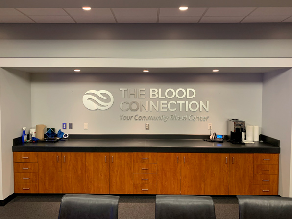 Dimensional lettering of the Blood Connection logo above conference room bar.