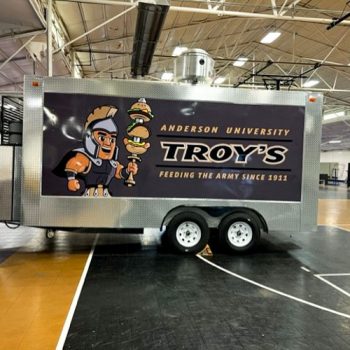 Full food trailer wrap for Anderson University with the mascot skewering food on his sword.