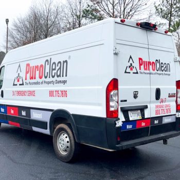 Partial vehicle wrap with cut logo and services for PuroClean van in Greenville, SC