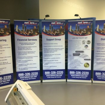 Lineup of 5 retractable banners displaying different facets of NetZero's branding.