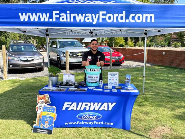 Bright blue tent and stretch table throw with logo and website for Fairway Ford
