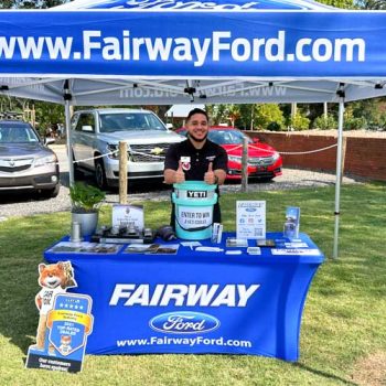 Bright blue tent and stretch table throw with logo and website for Fairway Ford