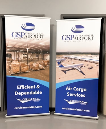 Two retractable banner stands with photos of cargo and planes for GSP airport.