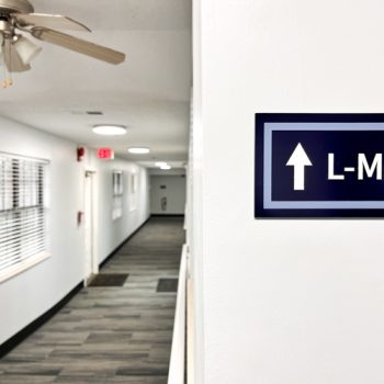 Directional signage made with acrylic and raised lettering for Serenity at Easley apartments