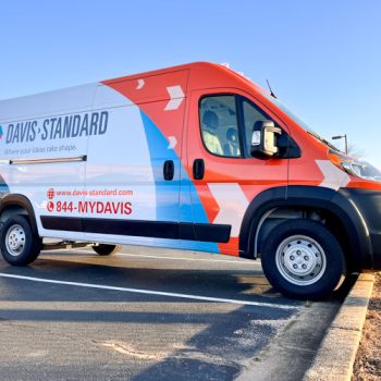 Orange and blue partial wrap on a fleet van for Davis-Standard