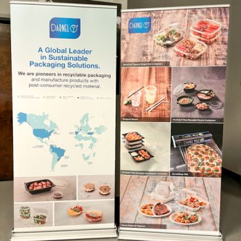Two custom retractable banner stands featuring images of food packaging and text for Darnel