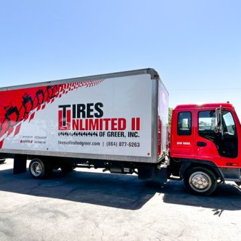 Full red, white and black box and cab wrap for large box truck in Tires Unlimited II's fleet in Greer, SC