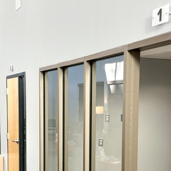 Acrylic numbering system using standoffs to hang numbers over room doors at The Blood Connection