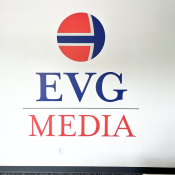 Large, custom cut logo decal on entrance wall at EVG Media in downtown Greenville, SC