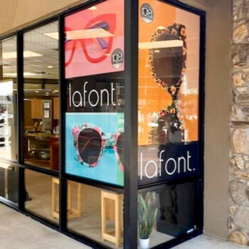 Window perf graphics depicting sunglasses on the storefront corner windows of a sunglasses company