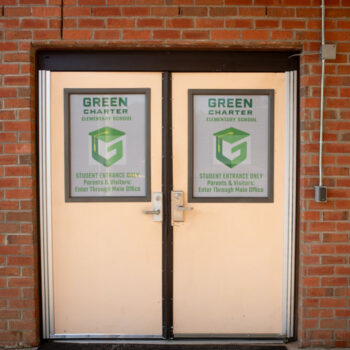 Window perf covering gym door windows marking doors as student entrance only at Green Charter Elementary School in Greenville, SC