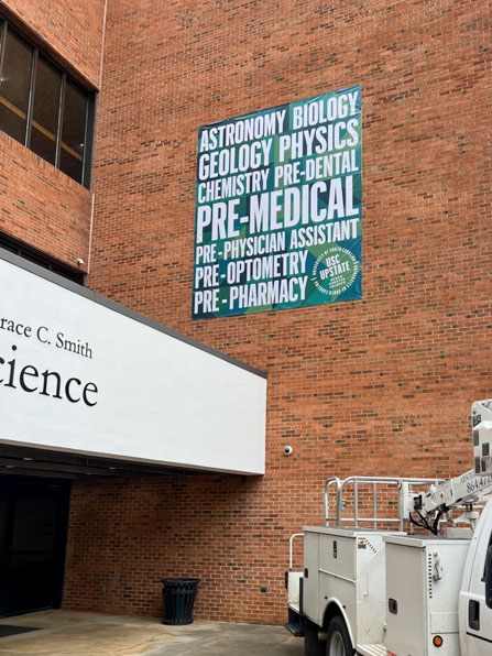 Large hanging banner at USC Upstate showcasing medical programs.