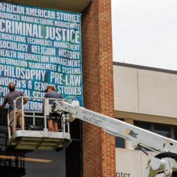 Installation of a super-format hanging banner showcasing collegiate programs of study at USC Upstate in Spartanburg, SC