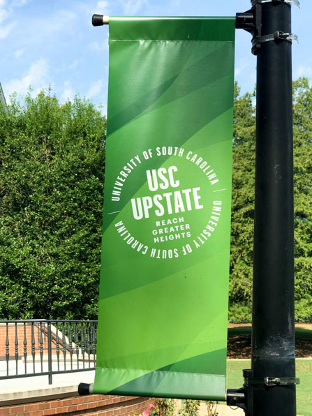 Pole banners showcasing school logo and colors for USC Upstate in Spartanburg, SC