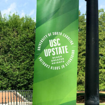 Pole banners showcasing school logo and colors for USC Upstate in Spartanburg, SC