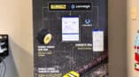 Retractable banner stand with infographic of products and uses for DeWALT