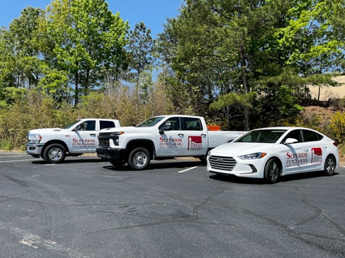Row of fleet vehicles with logos on vehicle sides.